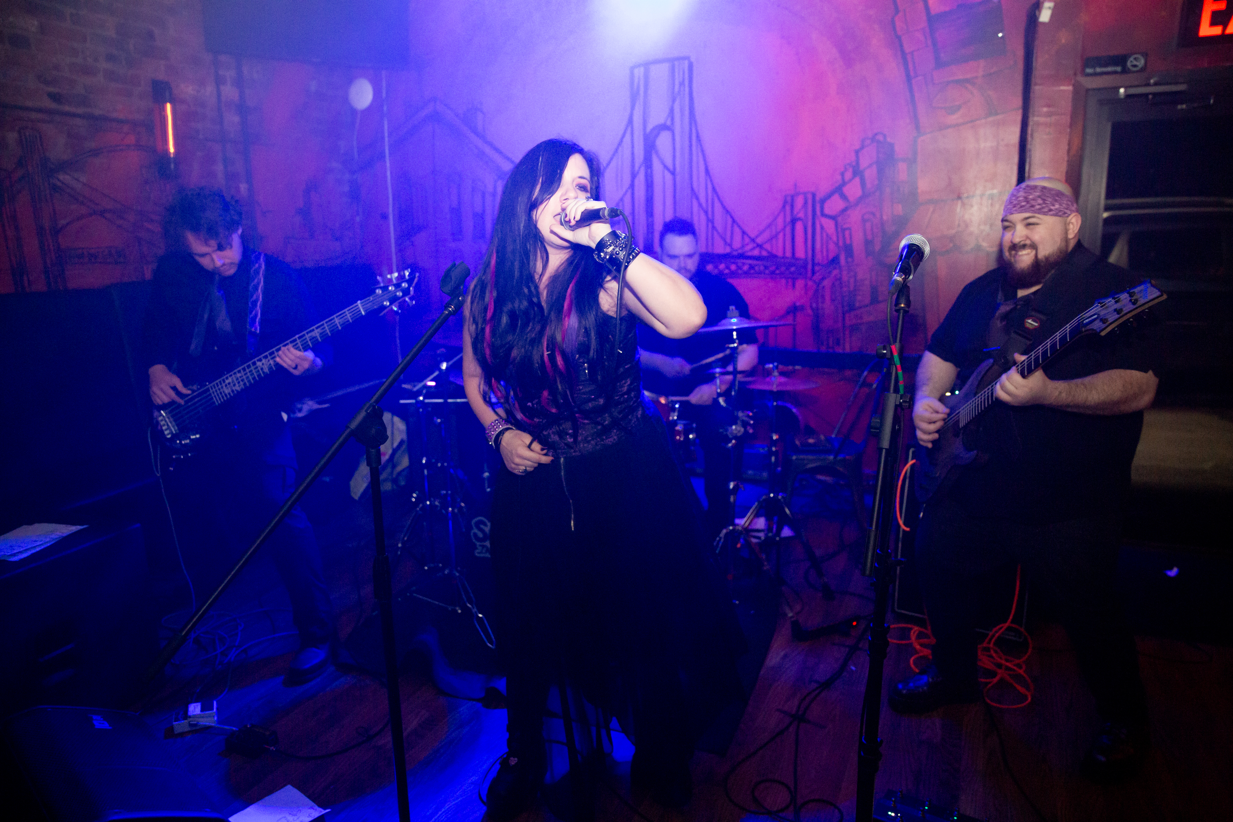 Surrender in Silence performing live in purple stage light
